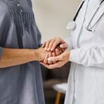 Doctor and patient holding hands