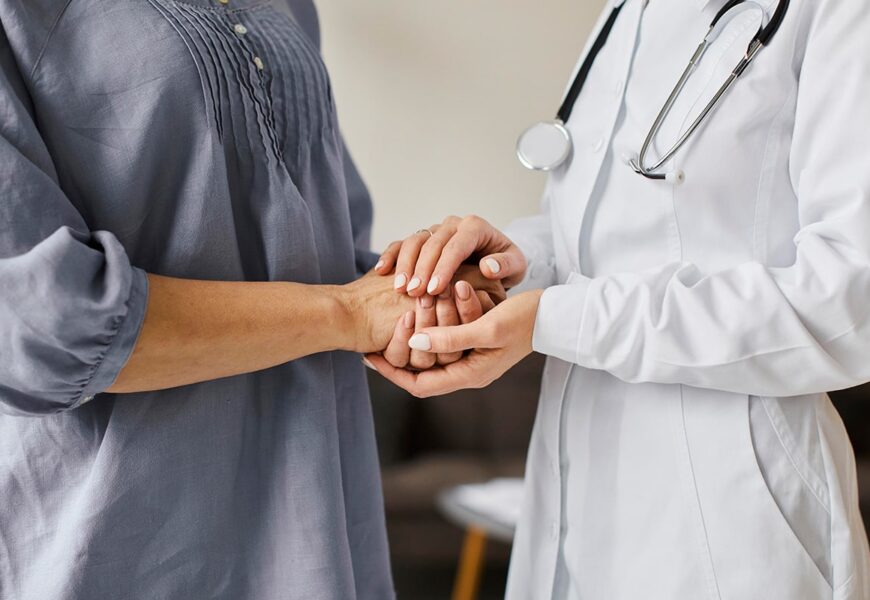 Doctor and patient holding hands